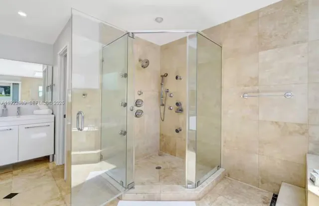 a bathroom with a shower and a sink