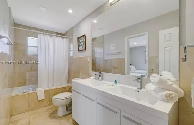 a view of bathroom with a sink mirror toilet and shower