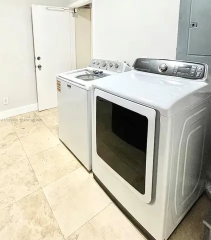 a utility room with washer and dryer