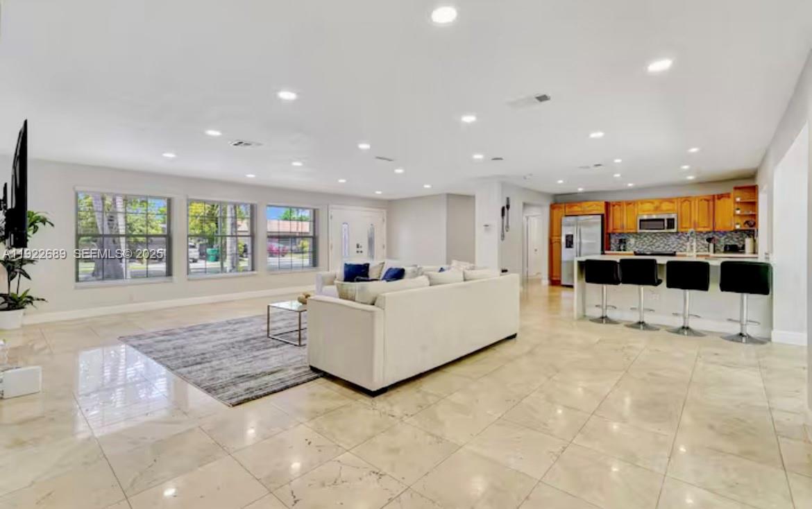 2080 Northeast 205th Street Miami, FL 33179 - Photo 5 of 24 a living room with furniture and a flat screen tv