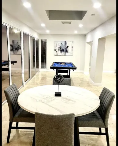 a dining room with furniture and window