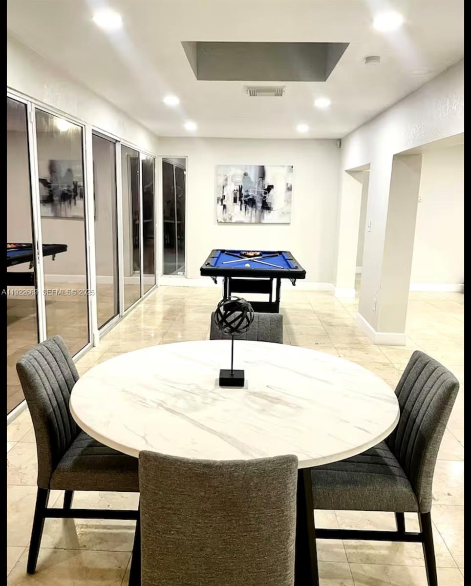 2080 Northeast 205th Street Miami, FL 33179 - Photo 9 of 24 a dining room with furniture and window
