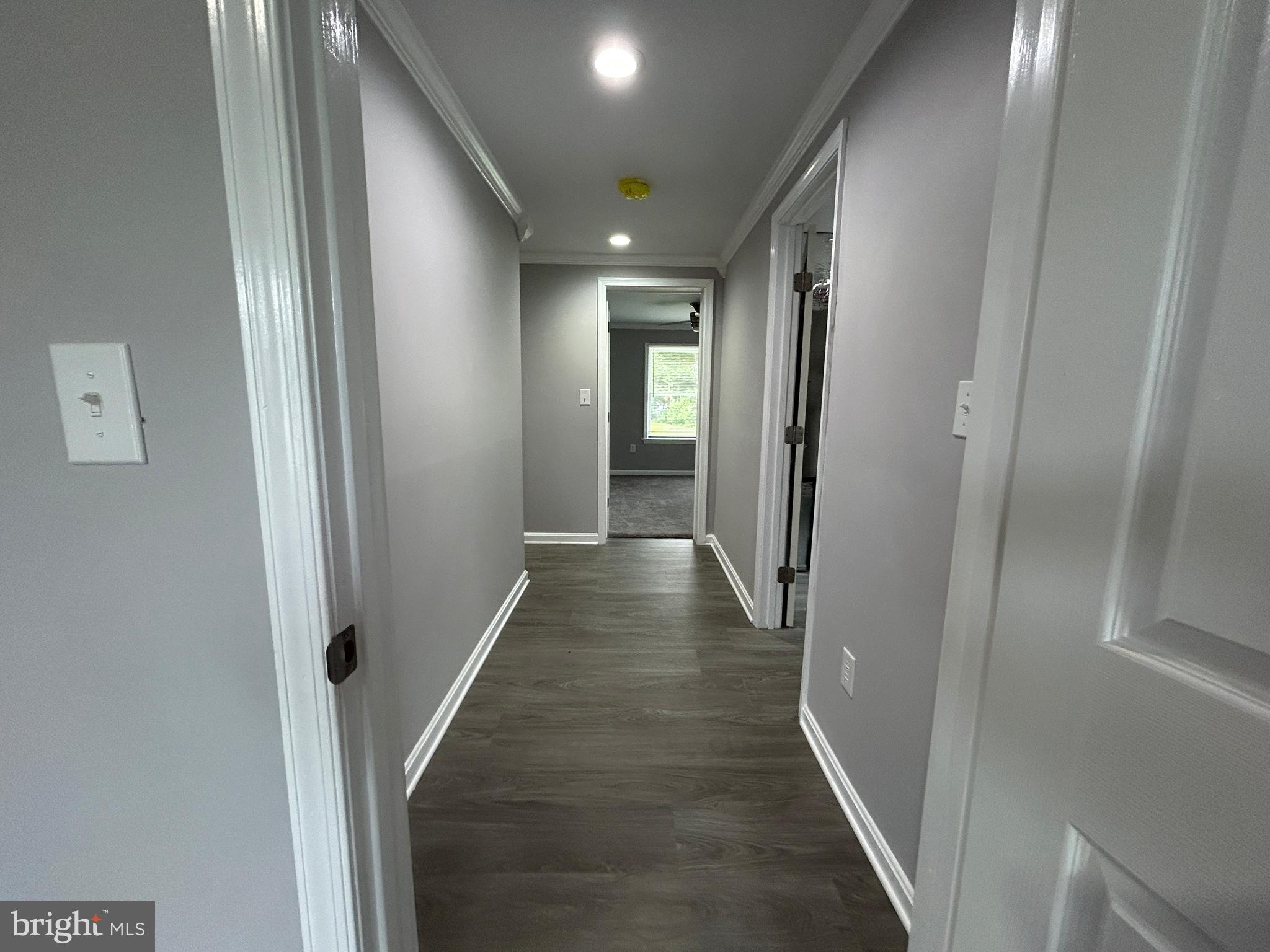 36697 Clubhouse Road Ocean View, DE 19970 - Photo 20 of 57 Hallway from Primary BD looking toward bedroom 3.
