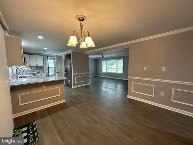 a stove top oven sitting inside of a kitchen
