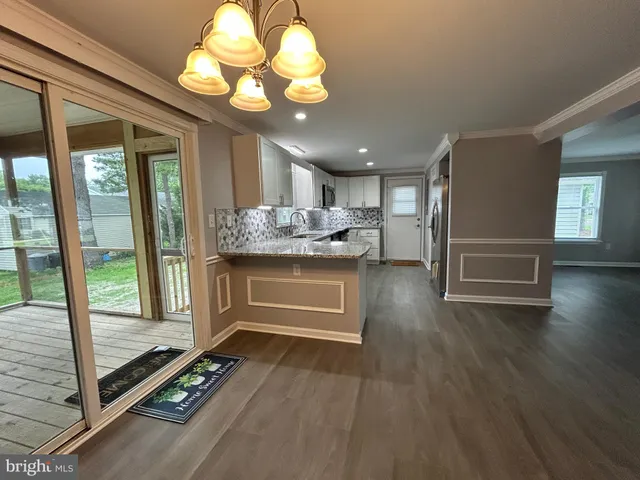 a kitchen with stainless steel appliances granite countertop a sink stove and microwave