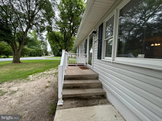 a view of a park with pathway and a yard