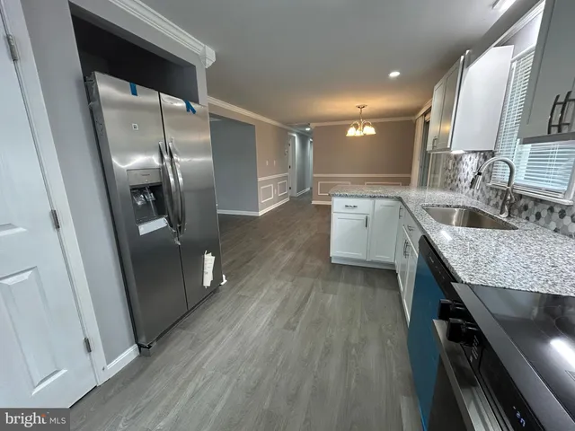 a kitchen with stainless steel appliances granite countertop a sink stove and microwave