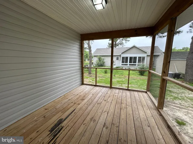 a view of a house with a big yard and large trees