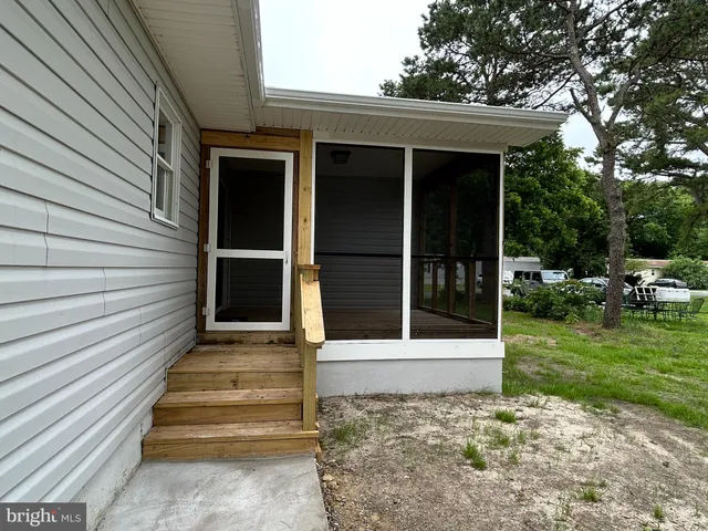 a house that has a tree in front of the house