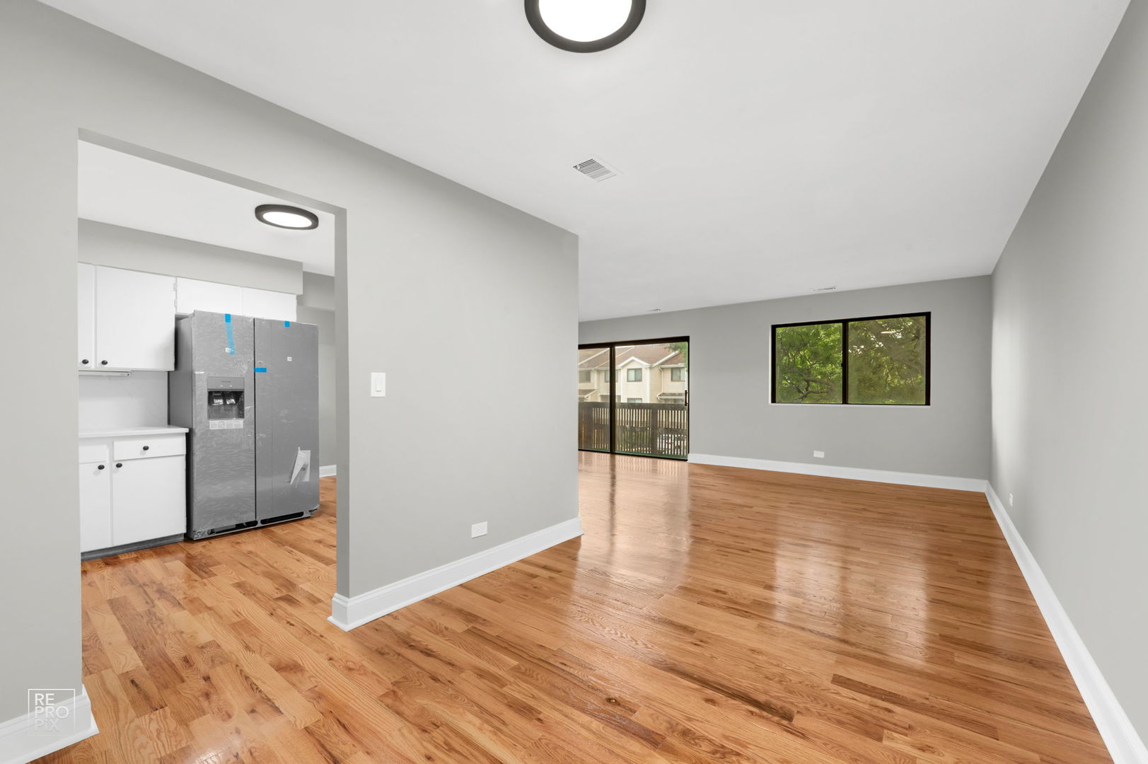 3110 Pheasant Creek Drive, Unit 206 Northbrook, IL 60062 - Photo 2 of 11 a view of an empty room with wooden floor and a window