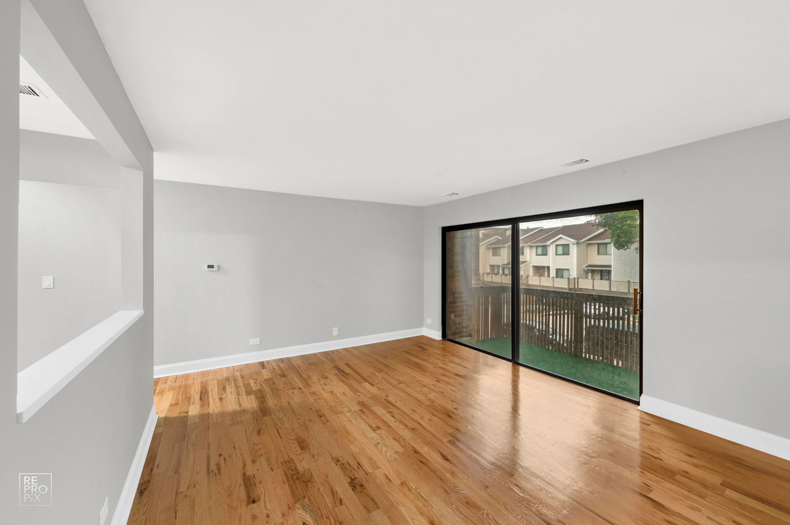 3110 Pheasant Creek Drive, Unit 206 Northbrook, IL 60062 - Photo 4 of 11 a view of an empty room with wooden floor and a window