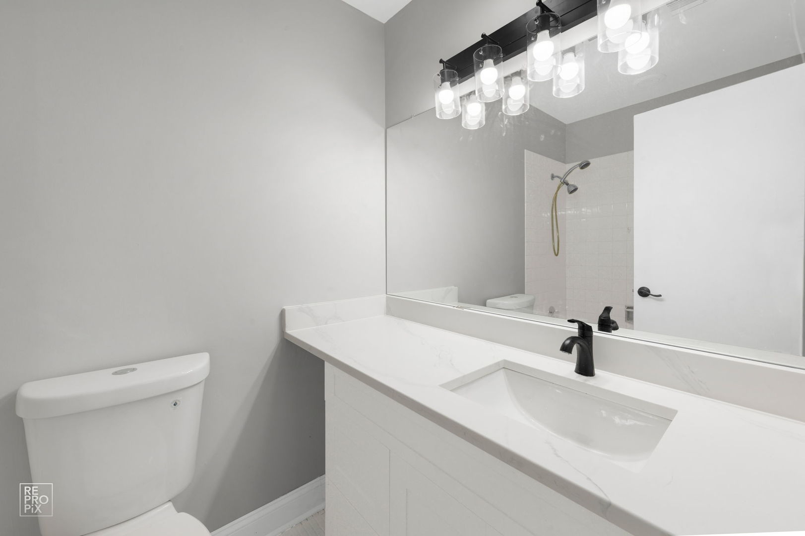 3110 Pheasant Creek Drive, Unit 206 Northbrook, IL 60062 - Photo 9 of 11 a bathroom with a sink a toilet and a mirror