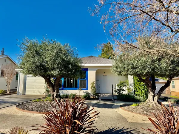 a view of a patio with table and chairs under an umbrella