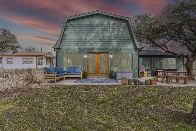 a view of a house with a yard patio and sitting area