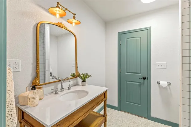 a bathroom with a sink and a mirror