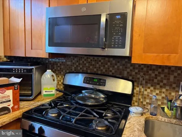 a stove top oven sitting inside of a kitchen