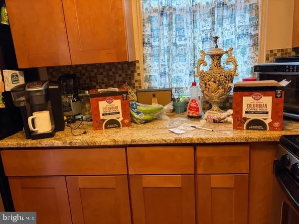 a kitchen with granite countertop sink and cabinets