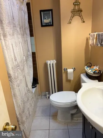 a white toilet sitting next to a bathroom sink