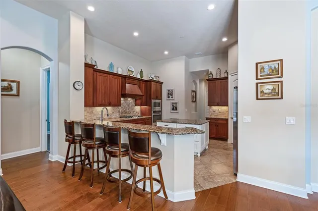 a kitchen with stainless steel appliances granite countertop a sink and cabinets