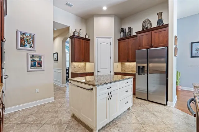 a kitchen with granite countertop stainless steel appliances and wooden cabinets