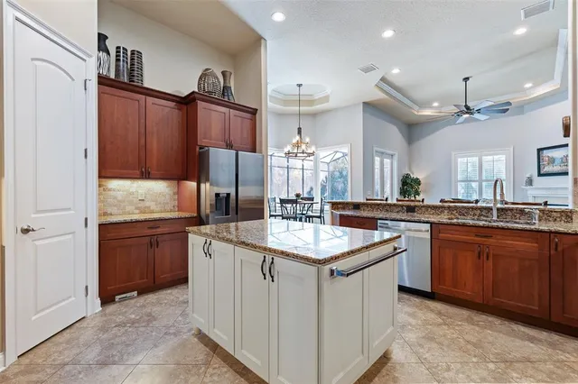 a view of a dining room with furniture a chandelier and wooden floor
