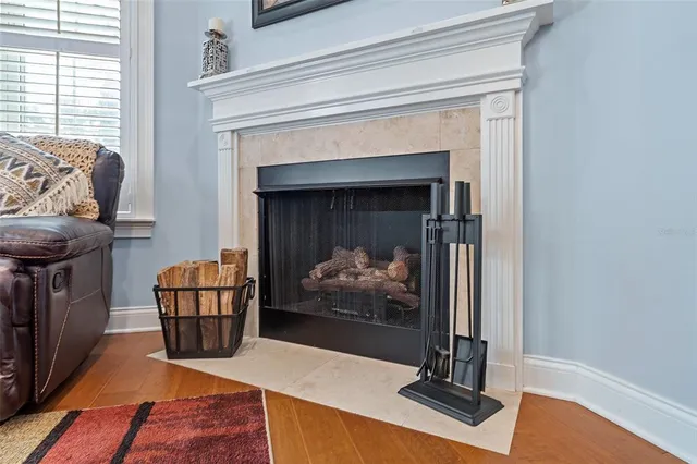 a bedroom with a bed and a dresser with wooden floor
