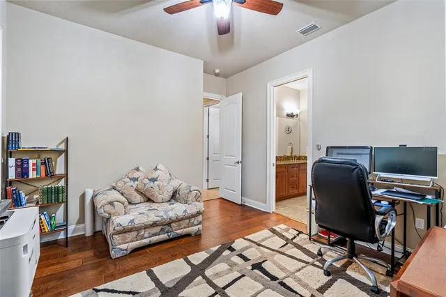 a view of a patio with table and chairs potted plants with floor to ceiling window and potted plants