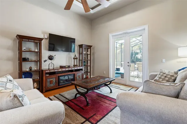 a view of a dining room with furniture a chandelier and wooden floor