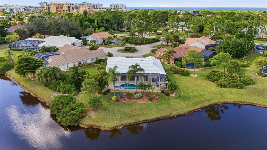 an aerial view of a house with a garden and lake view