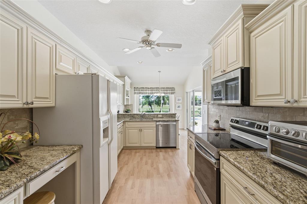 4030 Key Largo Lane Punta Gorda, FL 33955 - Photo 11 of 78 a kitchen with stainless steel appliances granite countertop a stove sink and cabinets