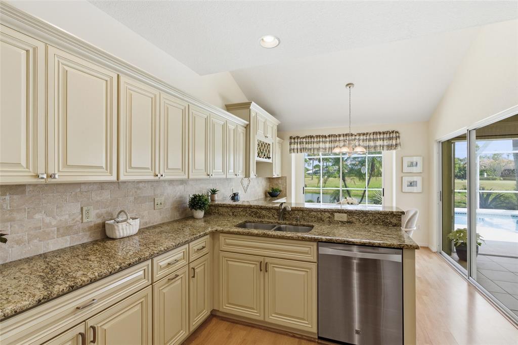 4030 Key Largo Lane Punta Gorda, FL 33955 - Photo 13 of 78 a kitchen with granite countertop a sink and white cabinets