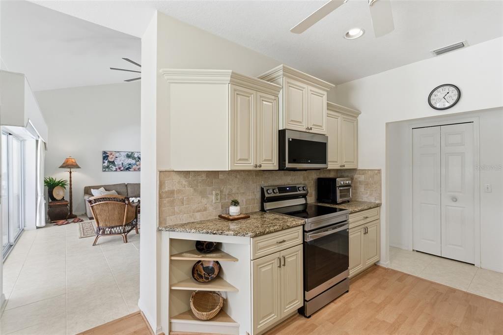 4030 Key Largo Lane Punta Gorda, FL 33955 - Photo 14 of 78 a kitchen with stainless steel appliances a stove a sink and a microwave