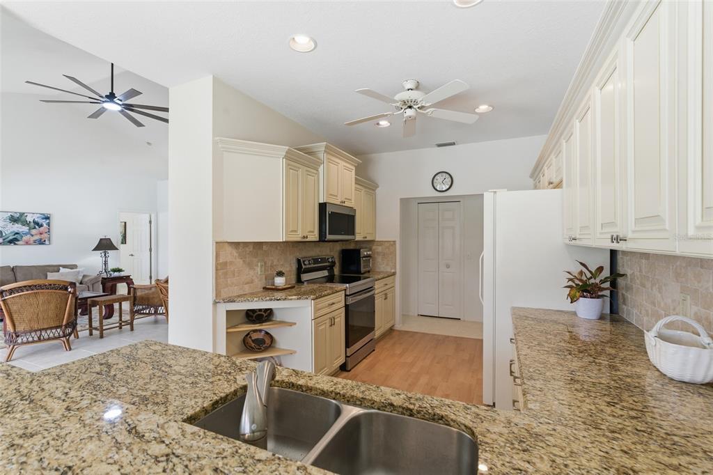 4030 Key Largo Lane Punta Gorda, FL 33955 - Photo 16 of 78 a kitchen with granite countertop a stove a sink and a refrigerator