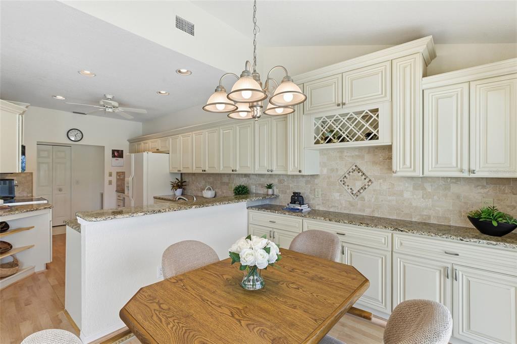 4030 Key Largo Lane Punta Gorda, FL 33955 - Photo 19 of 78 a kitchen with stainless steel appliances a table chairs and cabinets