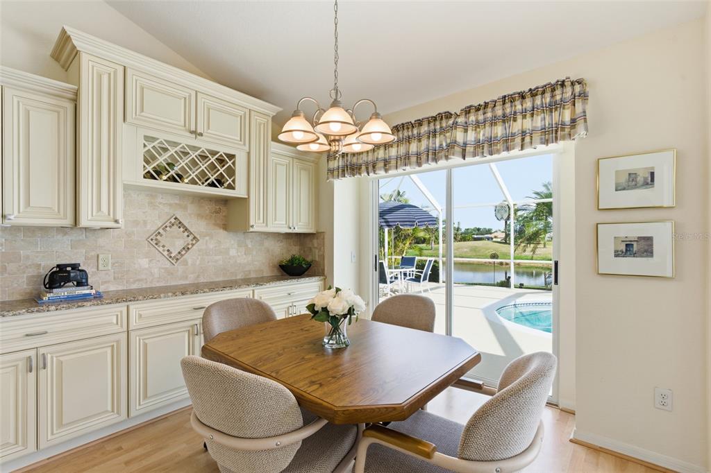 4030 Key Largo Lane Punta Gorda, FL 33955 - Photo 20 of 78 a view of a dining room with furniture a chandelier and wooden floor