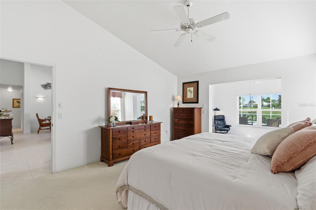 4030 Key Largo Lane Punta Gorda, FL 33955 - Photo 25 of 78 a large bedroom with a bed and a chandelier