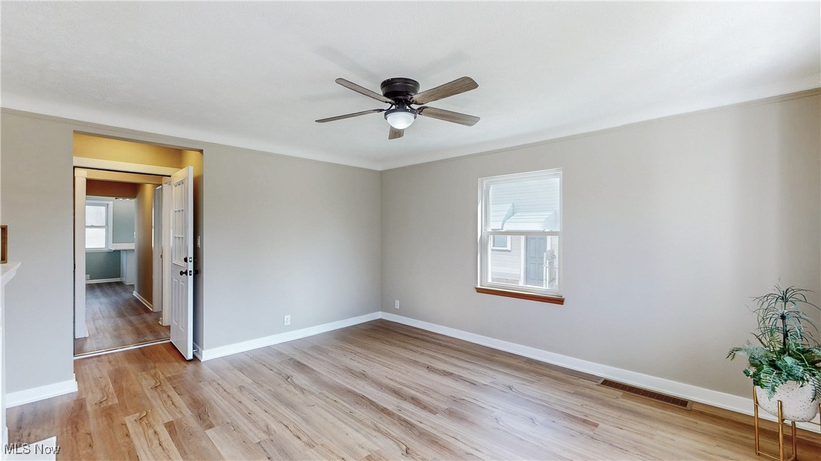 3318 Hearthstone Road Cleveland, OH 44134 - Photo 5 of 35 Unfurnished room with visible vents, baseboards, light wood-style flooring, and a ceiling fan