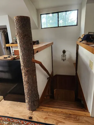 a view of a house with a small yard and wooden fence