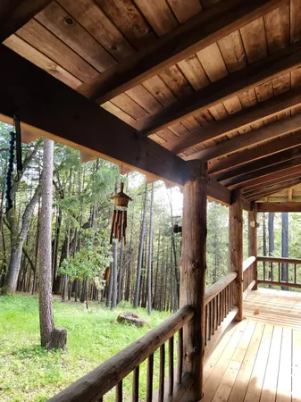a backyard of a house with a yard and outdoor seating