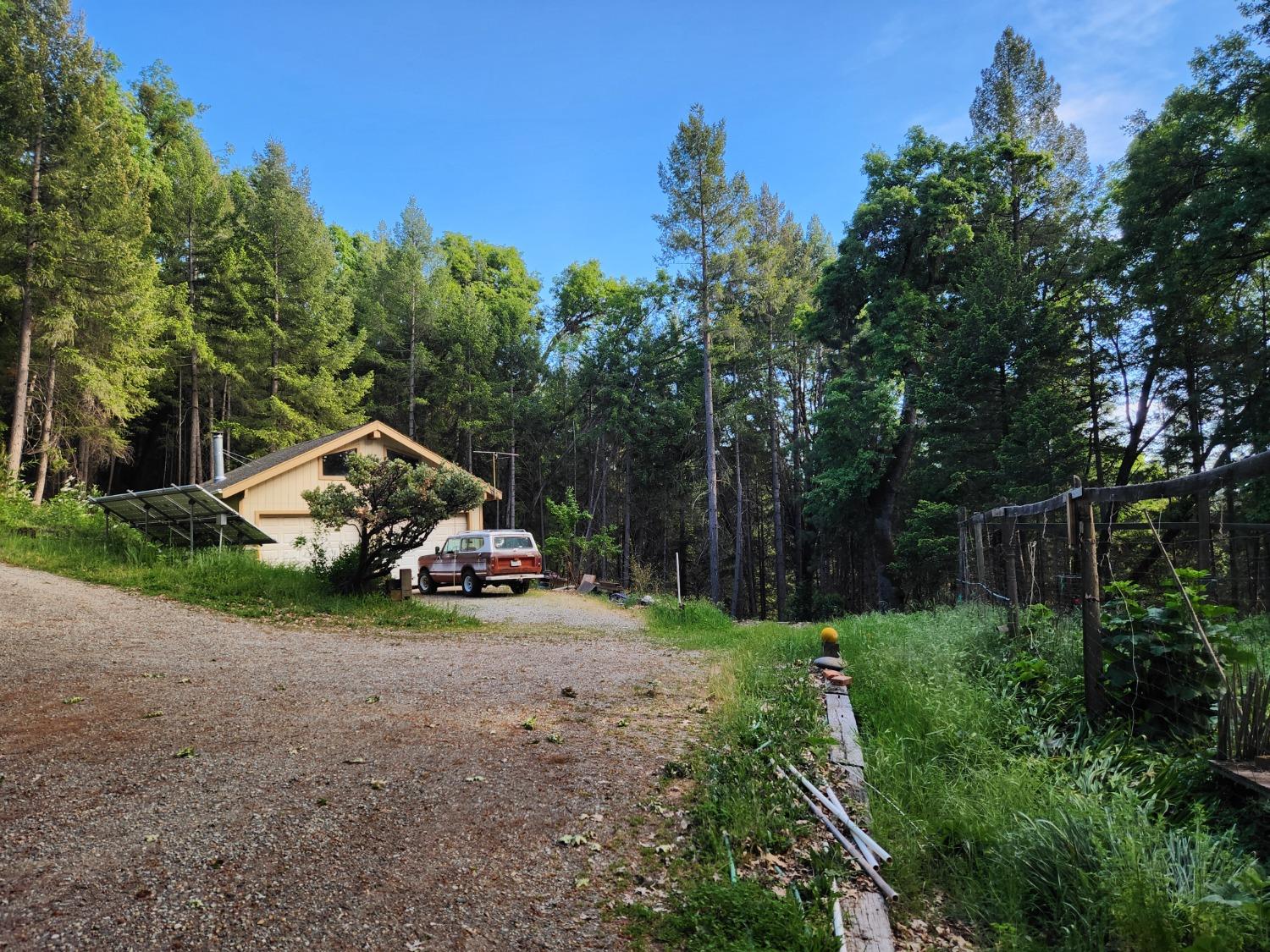 18253 Green Ravine Road Nevada City, CA 95959 - Photo 26 of 43 a view of a house with a small yard and sitting area