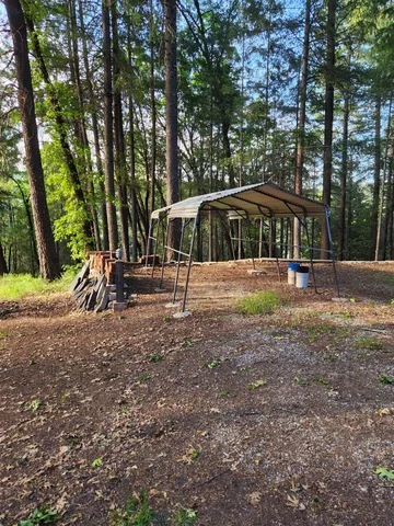a view of outdoor space with deck and trees