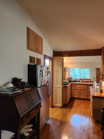 a kitchen with stainless steel appliances granite countertop a stove refrigerator and cabinets