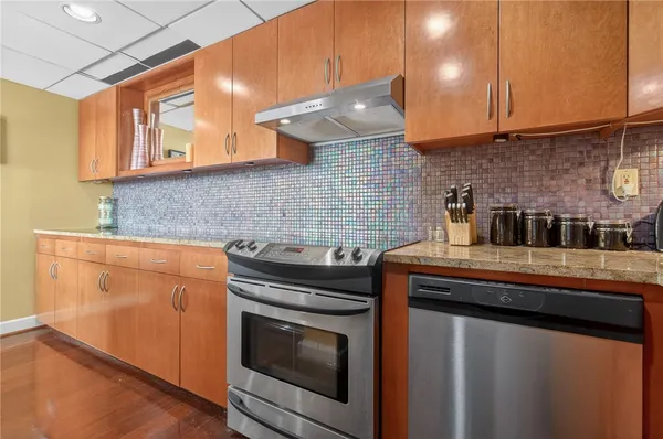 a kitchen with granite countertop a stove and a sink