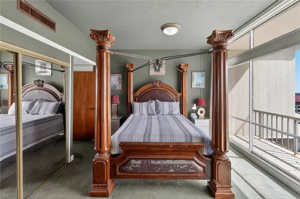 a bedroom with a bed and a large window