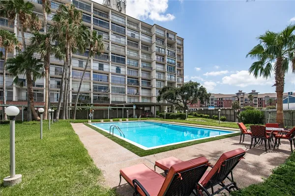 a view of an outdoor space with swimming pool and sitting area