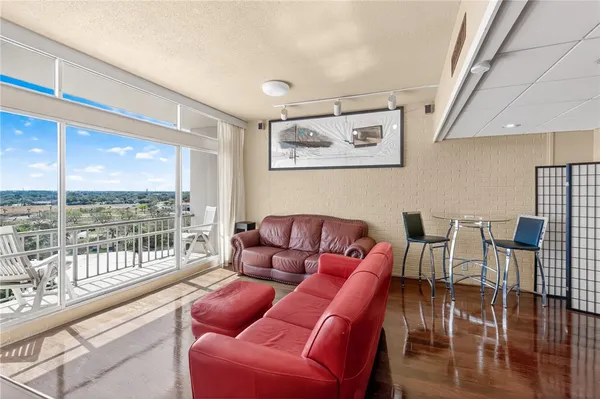 a media room with lots of chairs and a large window