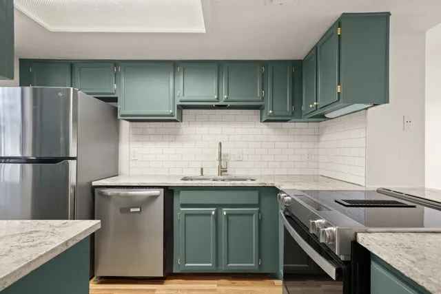 a kitchen with granite countertop a sink and cabinets