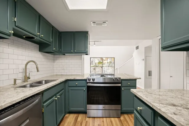 a bathroom with a toilet sink vanity and mirror