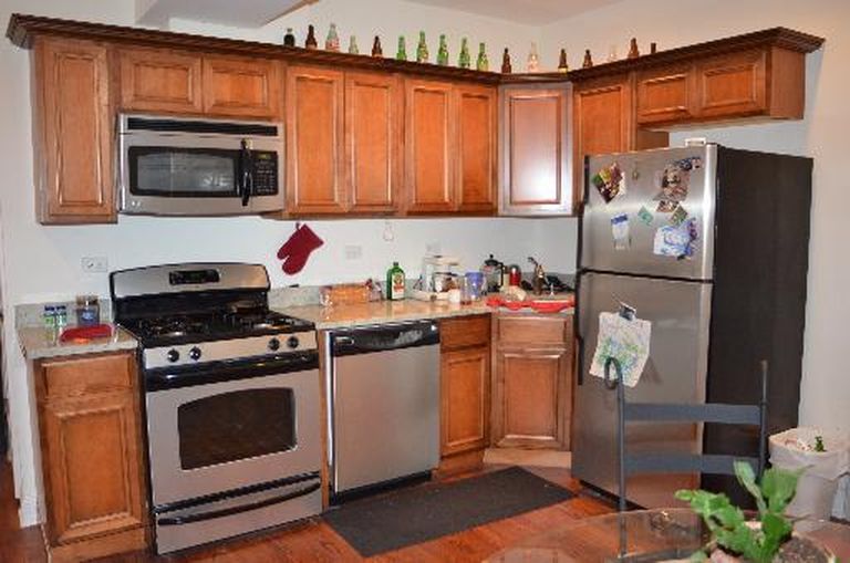 4751 North Virginia Avenue, Unit 2 Chicago, IL 60625 - Photo 2 of 8 a kitchen with stainless steel appliances granite countertop a refrigerator stove and sink