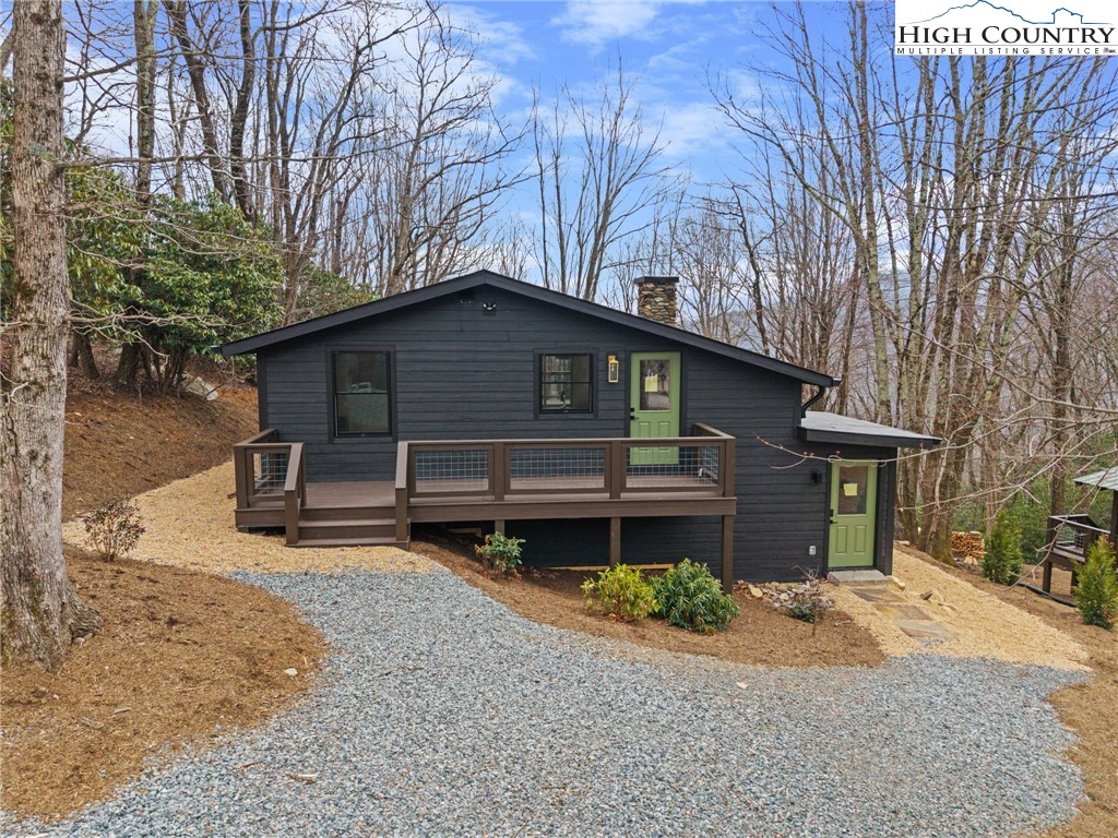 212 Chinkapin Ridge Road Seven Devils, NC 28604 - Photo 1 of 21 a front view of a house with garden